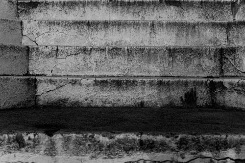 Free Monochrome photo of textured concrete stairs, showcasing cracks and urban decay. Stock Photo
