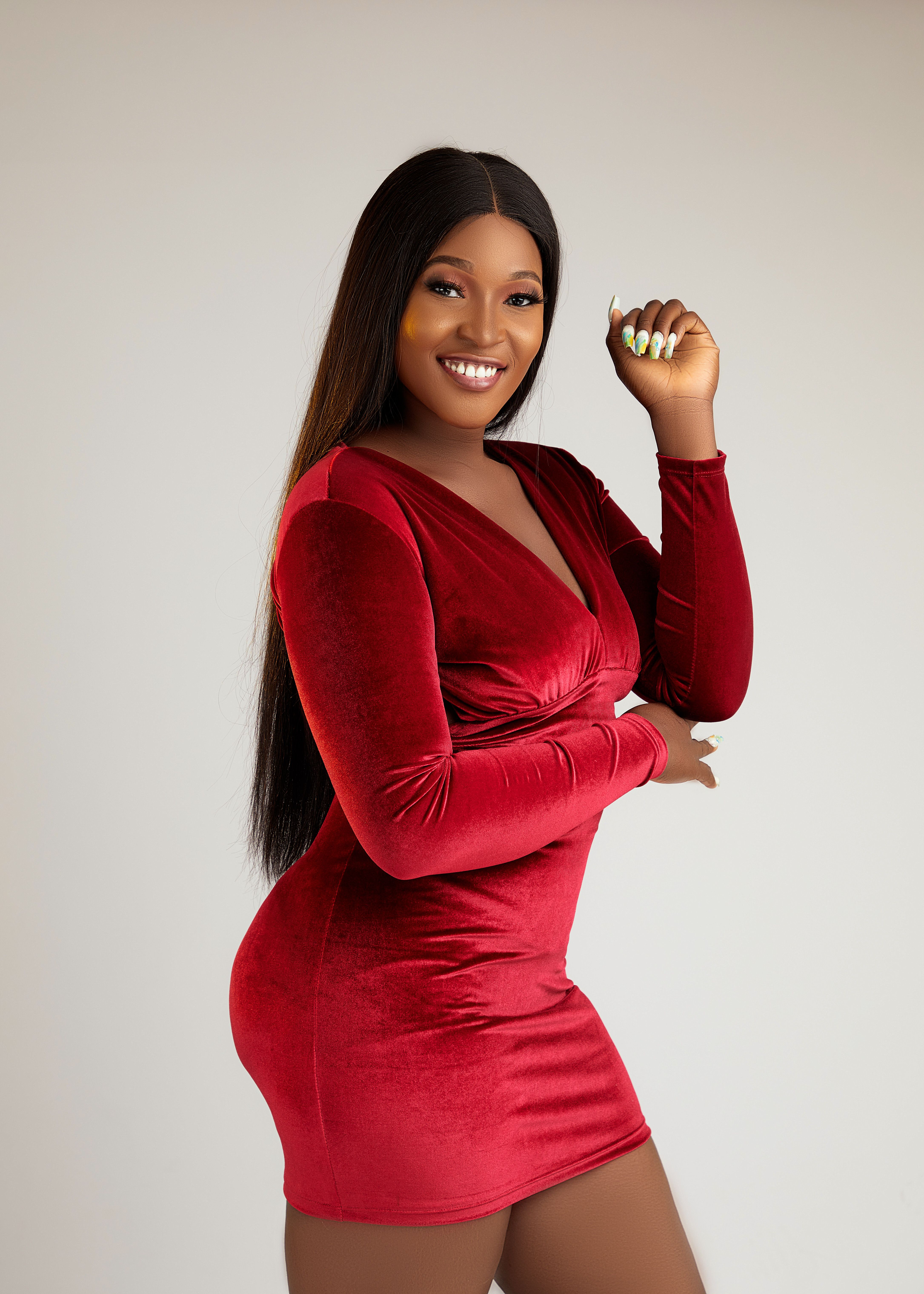 Elegant Woman in Red Velvet Dress Posing Confidently · Free Stock Photo