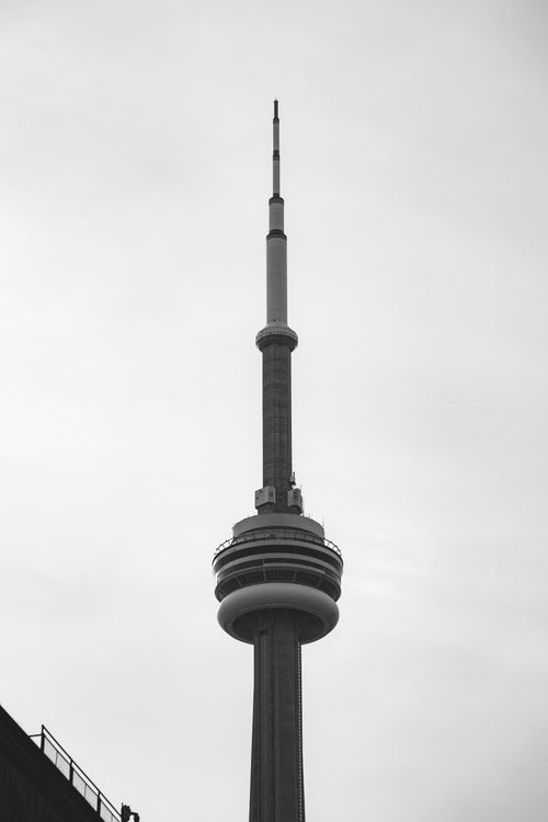 Free A striking black and white image of the CN Tower set against a cloudy sky in Toronto. Stock Photo