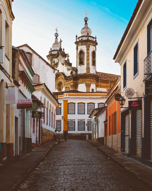 Free Charming cobblestone street with historic church in Ouro Preto, Brazil's colonial architecture. Stock Photo