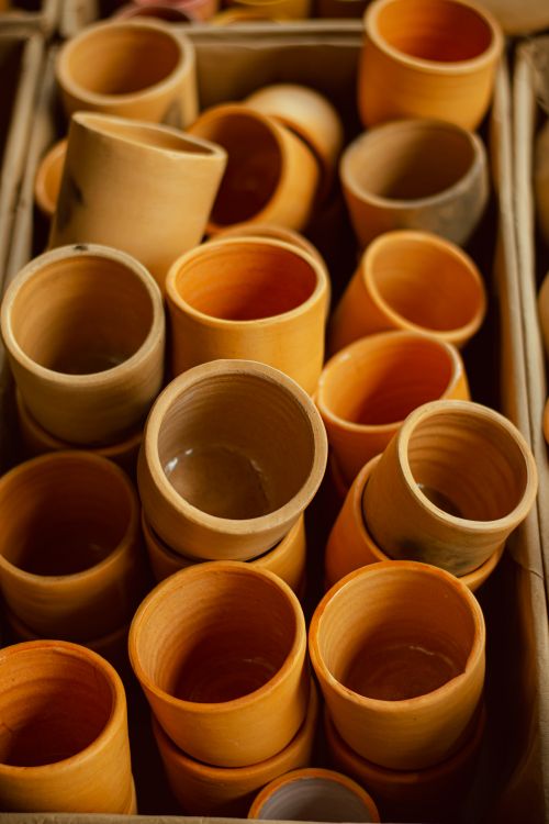 Free Collection of traditional clay cups in warm hues, perfect for artisanal and earthy concepts. Stock Photo