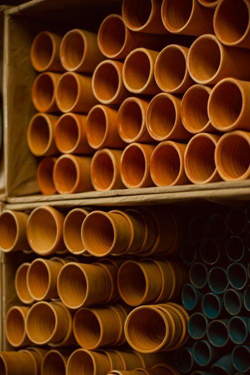 Free Organized rows of industrial pipes in a warehouse setting showcasing manufacturing and construction materials. Stock Photo