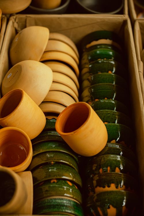 Free A vibrant collection of clay and ceramic pots arranged neatly in a cardboard box, showcasing traditional craftsmanship. Stock Photo