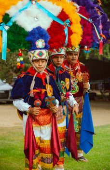 Colorful traditional Mexican dancers in vivid costumes during a cultural festival.