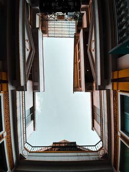 A striking low-angle view of urban buildings with a clear sky backdrop.