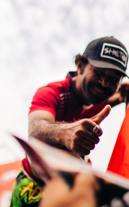 Free Man in Red Shirt Wearing Black Cap Stock Photo