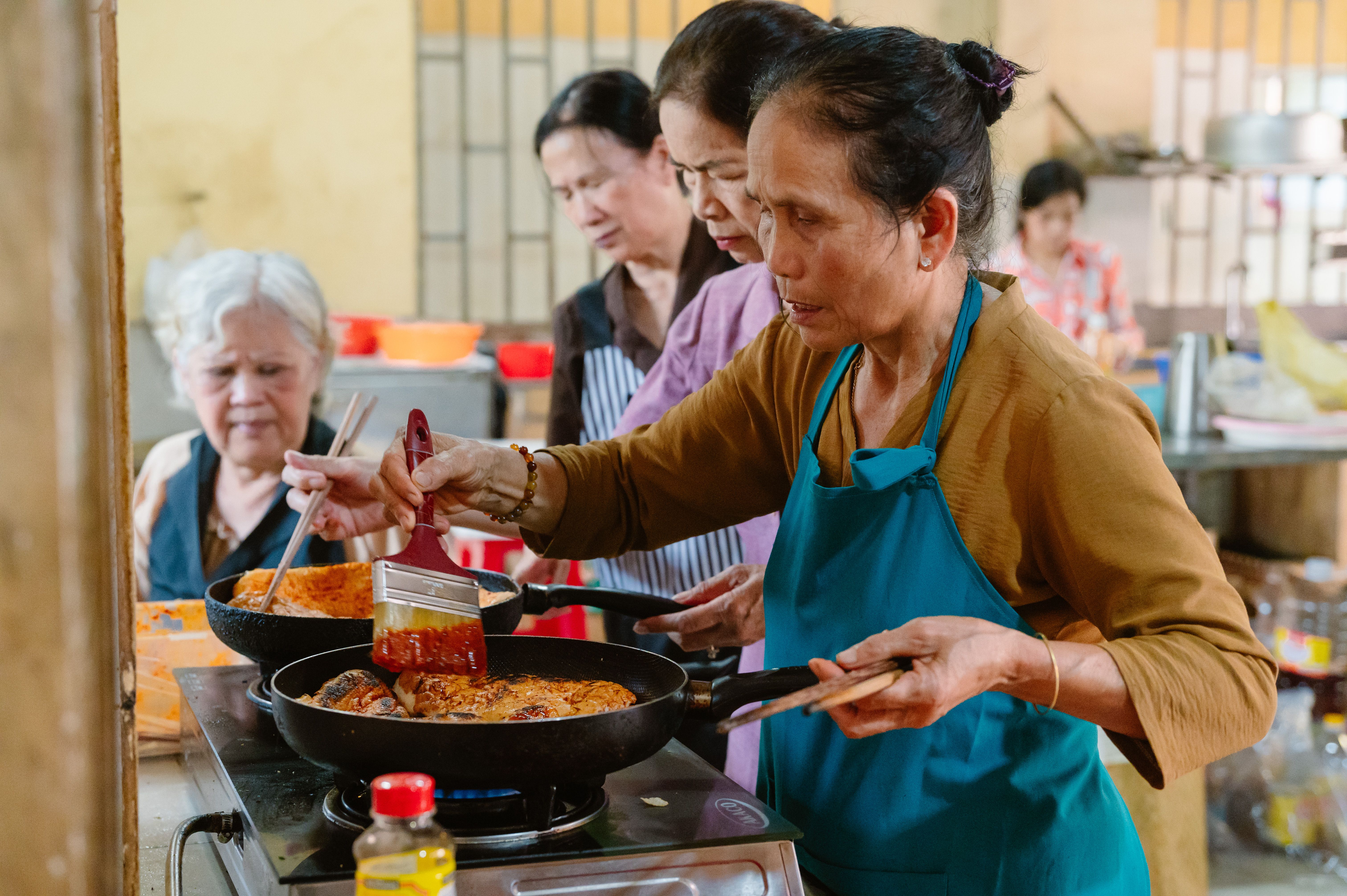 Group of Women Cooking Together in a Kitchen · Free Stock Photo