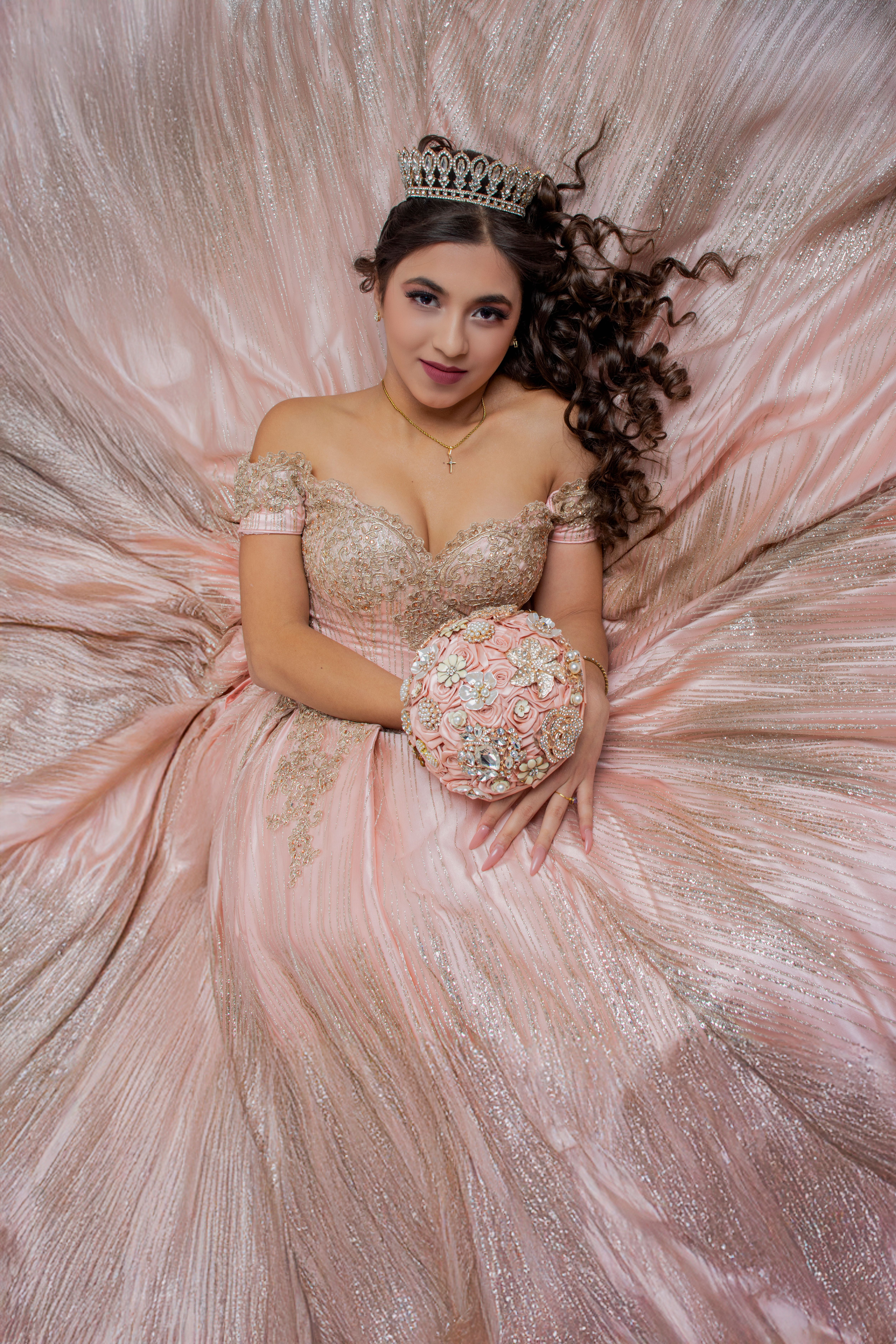 Illustrative portrait of a young woman in a pink quinceanera gown.