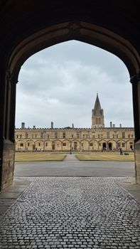 View of the iconic Christ Church College in Oxford, featuring classic architecture and a dramatic sky.