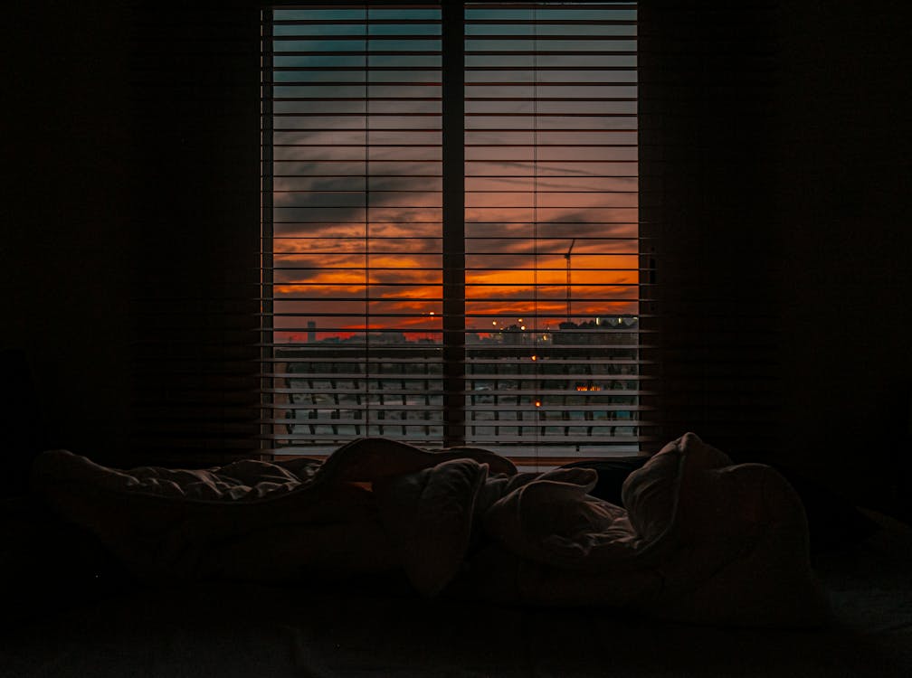 Free Crumpled blanket in dark room at sunset Stock Photo