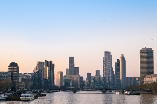 Free A picturesque view of London's skyline over the River Thames at sunset. Stock Photo