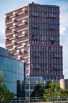 Contemporary high-rise apartment building with balconies in Almere, Netherlands.