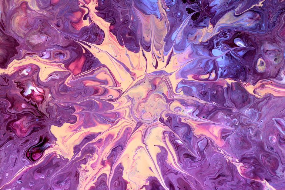 Abstract fluid art with vibrant purple and pink swirls creating an artistic visual effect.