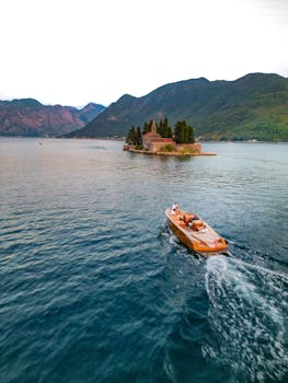 Luxury motorboat cruising near island in Kotor Bay, Montenegro