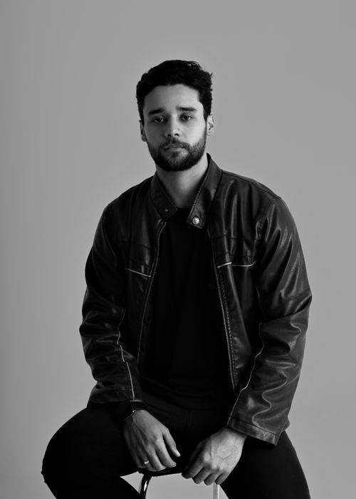 Free Striking black and white portrait of a man wearing a leather jacket, exuding confidence. Stock Photo