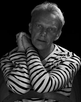Black and white portrait of a man wearing a striped shirt, Bretagne style.