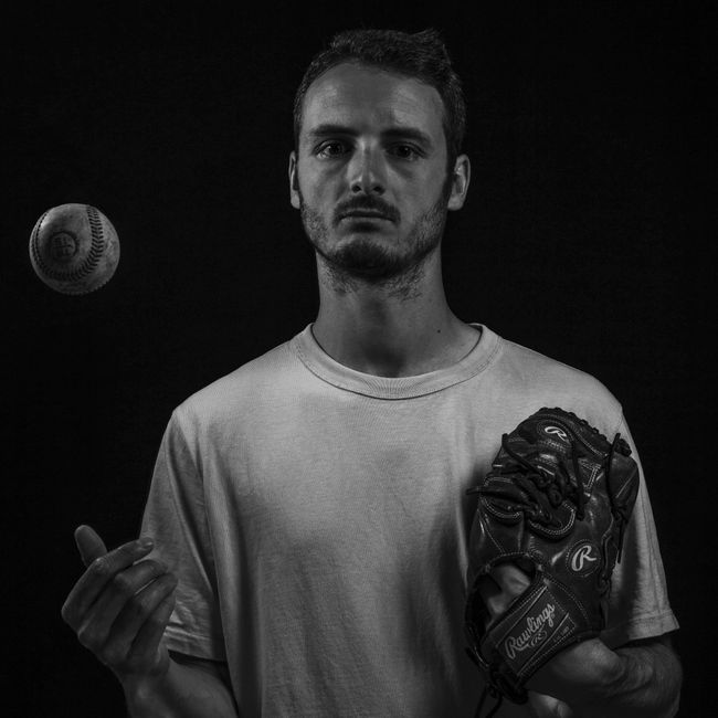 man handing baseball glove