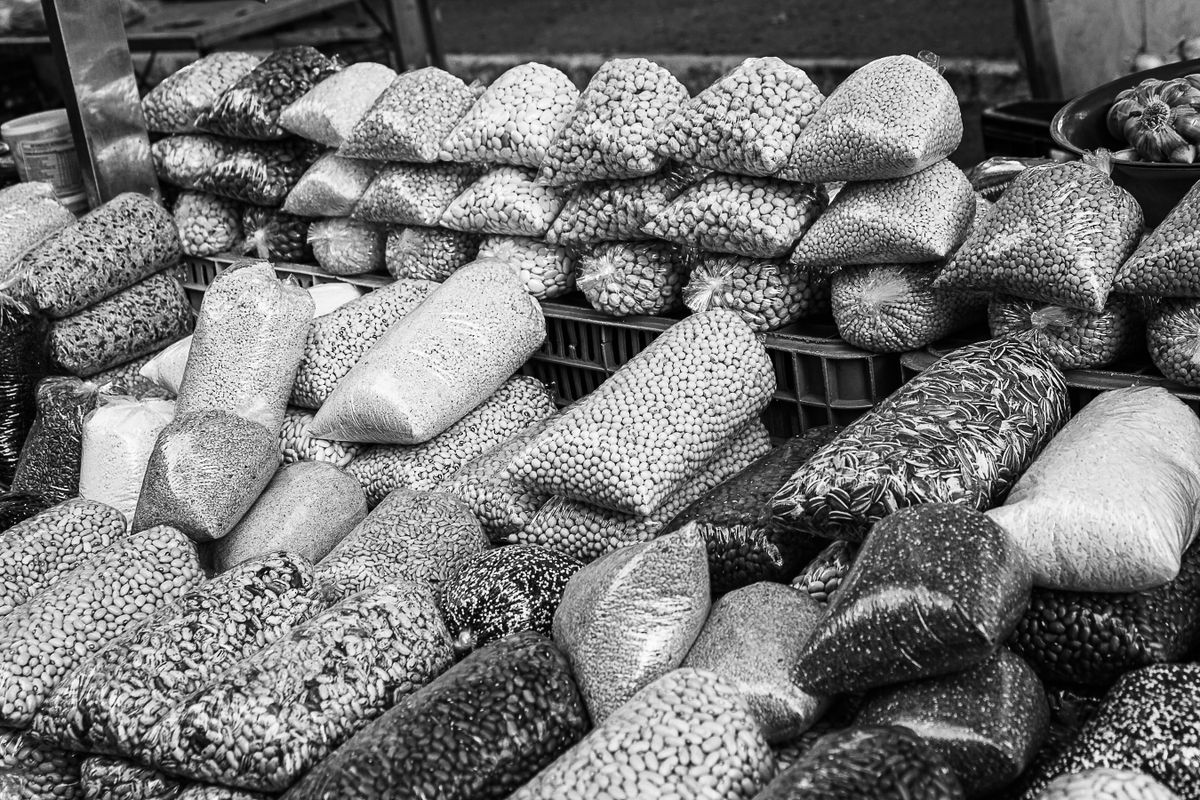 Variety of grains and pulses displayed in a market, representing Dhule's dal and pulse processing trade