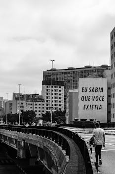 Black and white urban cityscape in São Paulo featuring prominent graffiti on a wall.