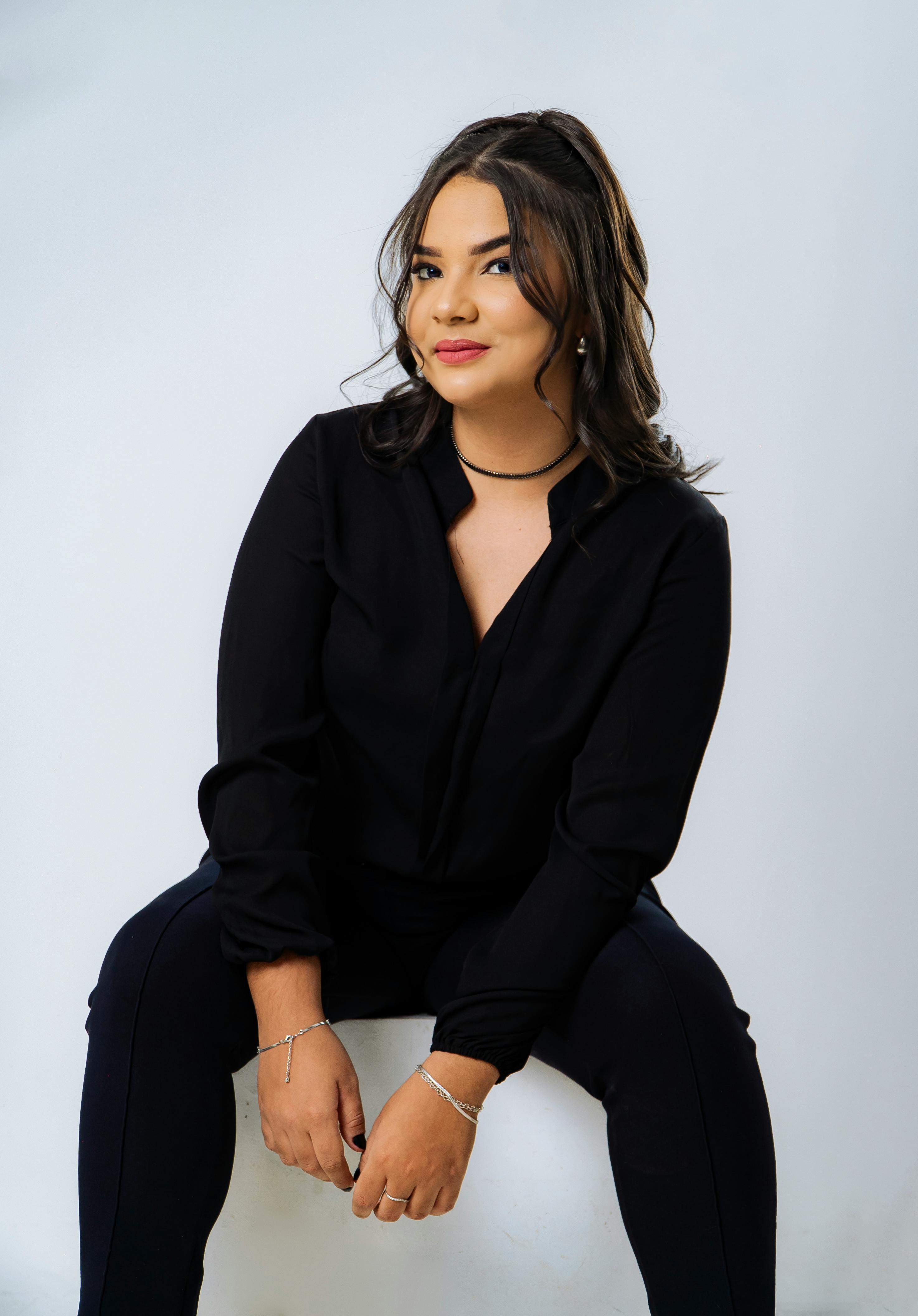 Portrait of a confident woman in a black outfit, showcasing elegance and poise.