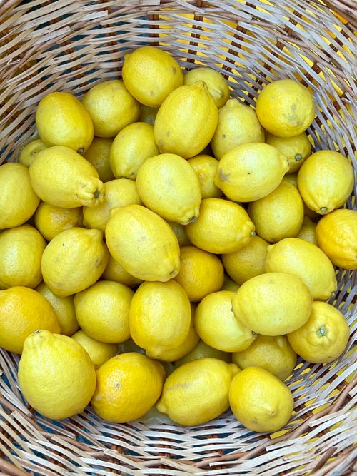 Free Fresh yellow lemons overflow in a woven basket, highlighting vibrant colors and textures. Stock Photo