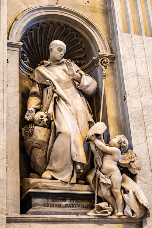 Free Detailed marble statue of a saint with an angel, captured in a historic cathedral setting. Stock Photo