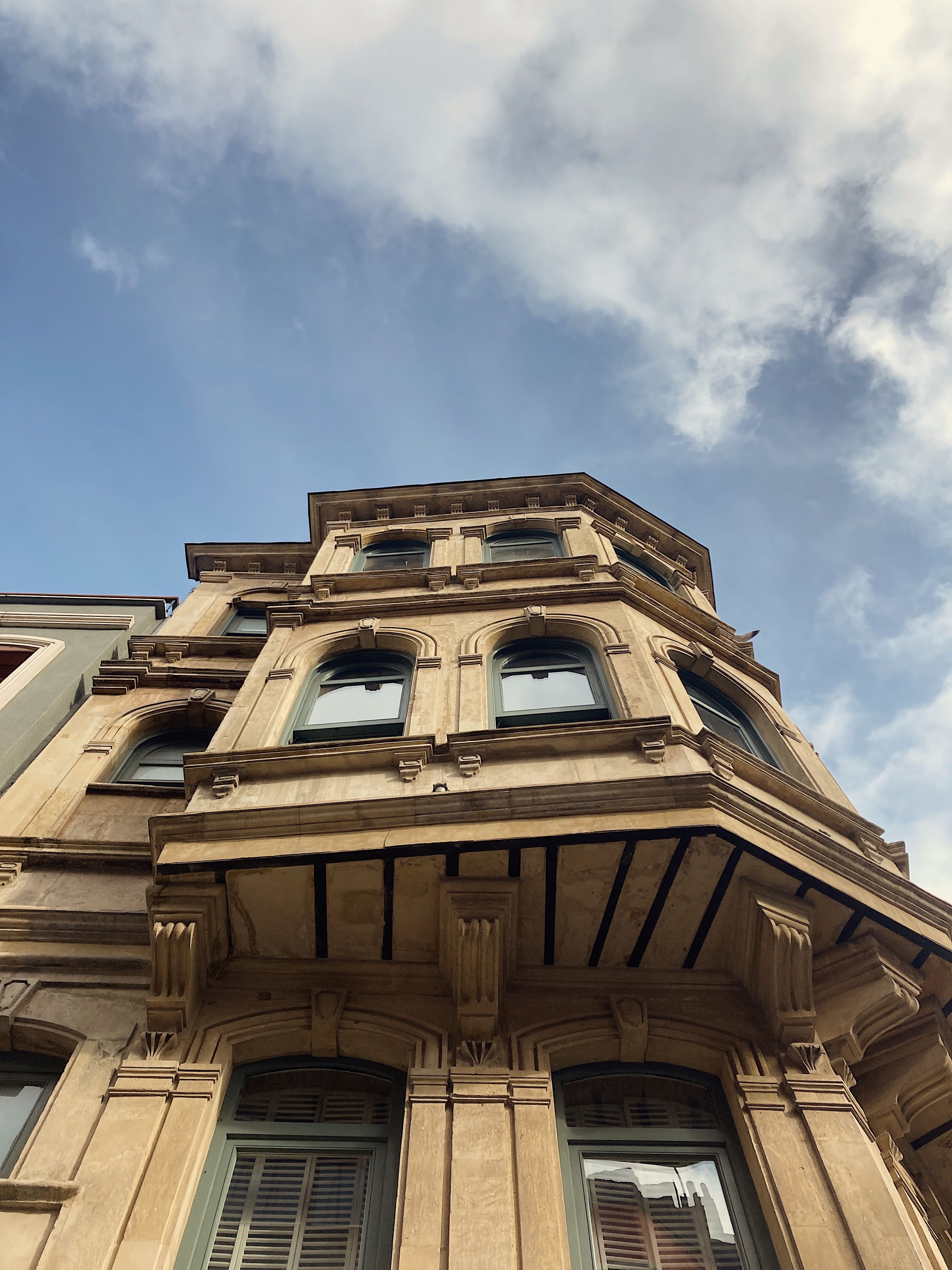 Historical Building Facade Under Blue Sky · Free Stock Photo