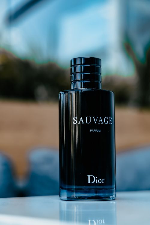 Free Stylish Dior Sauvage perfume bottle, elegantly displayed outdoors with a blurred background. Stock Photo