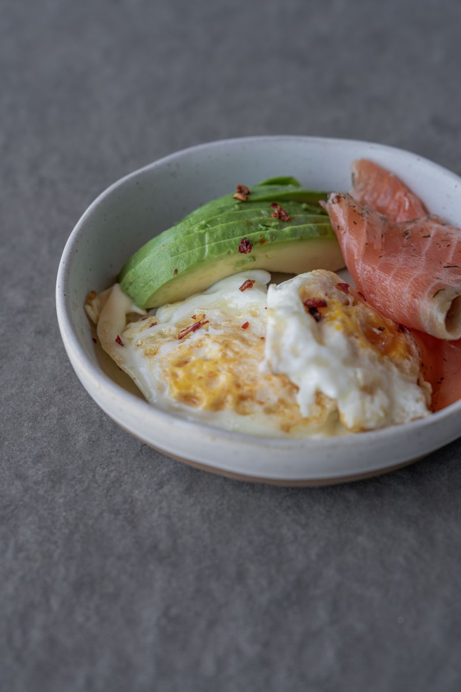 Breakfast bowl with eggs, avocado and salmon