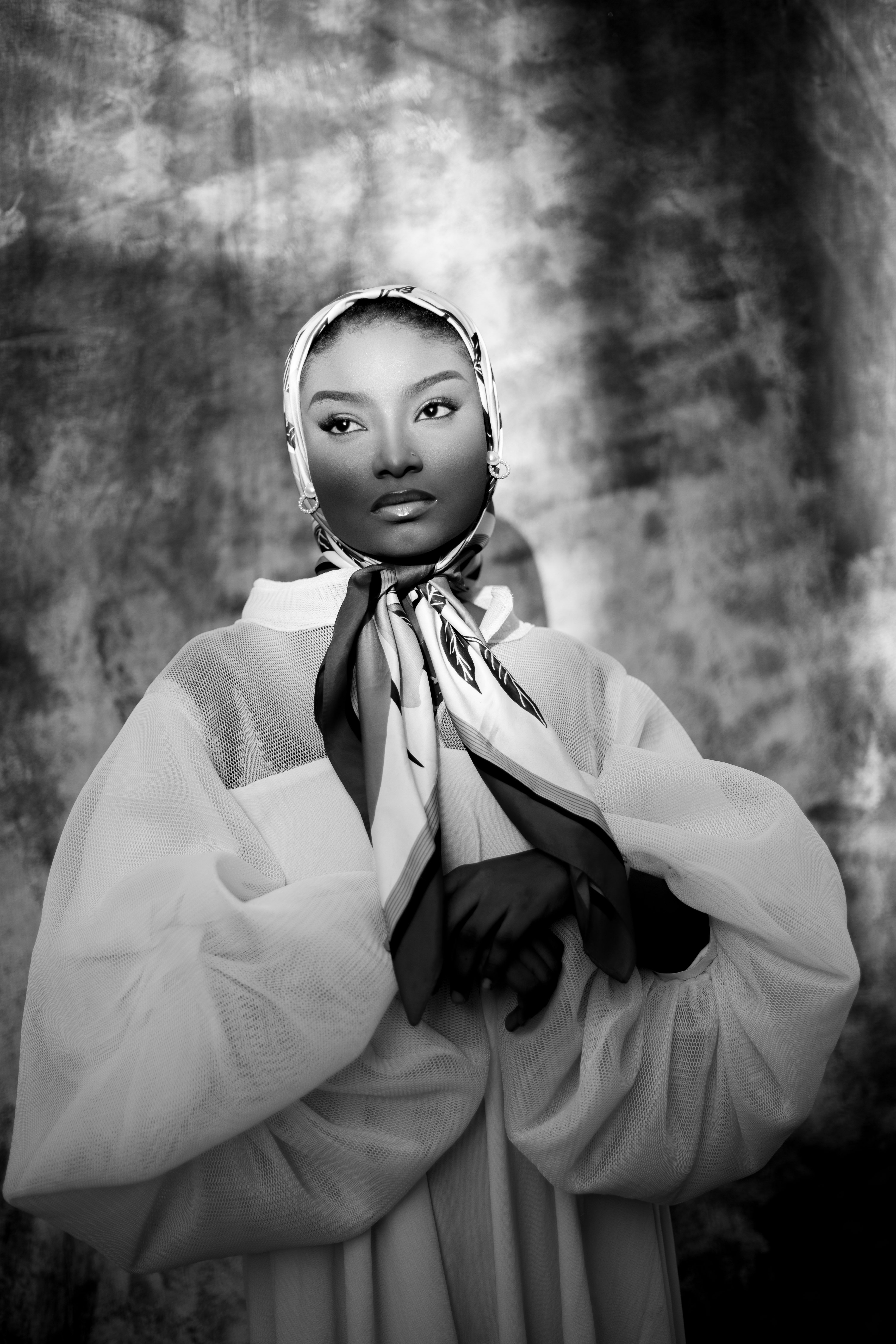Stunning black and white portrait of a woman in a scarf and elegant attire, creating a classic and dramatic look.
