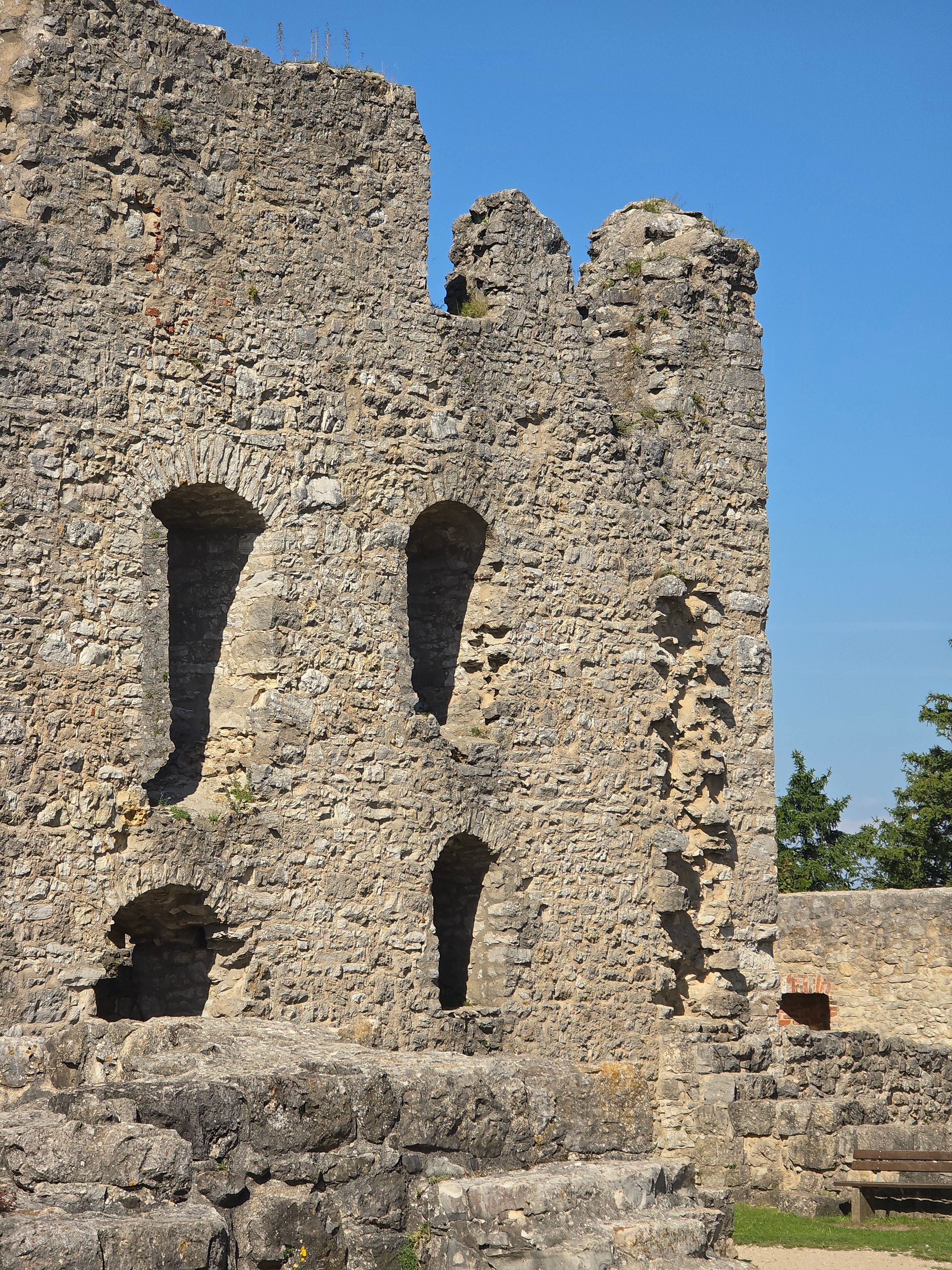 Capture of ancient stone castle ruins on a sunny day with a clear blue sky.