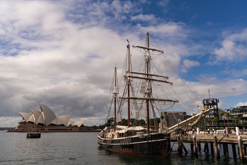 Free Sailing ship moored near Sydney Opera House on a vibrant day in Sydney. Stock Photo