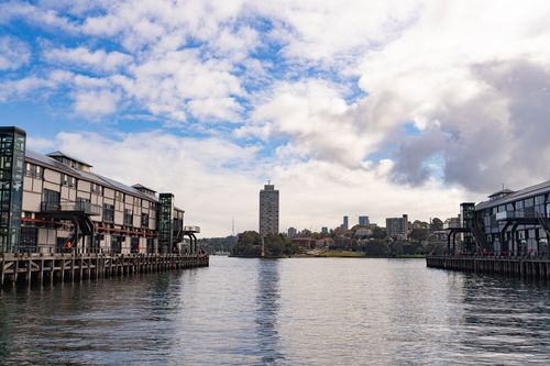 Free A picturesque view of Sydney's waterfront with modern architecture and blue sky reflections. Stock Photo