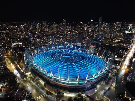 Illuminated BC Place Stadium in Vancouver at night, showcasing stunning cityscape views.