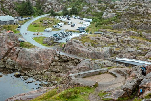 Explore the rugged landscape and bustling activity at Lindesnes, Agder, Norway, featuring campers and nature.