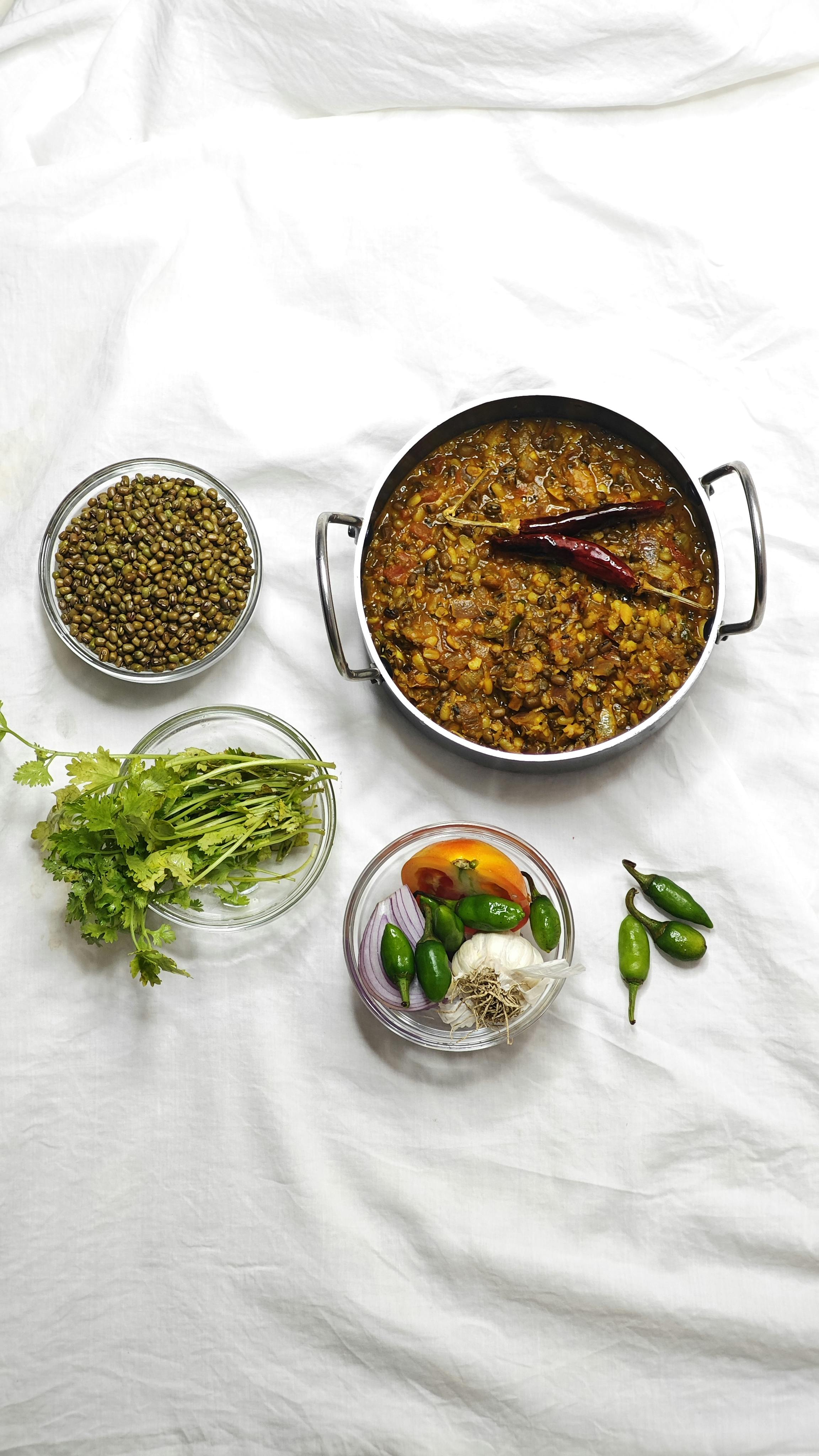 Top view of Indian lentil dish with spices and herbs.