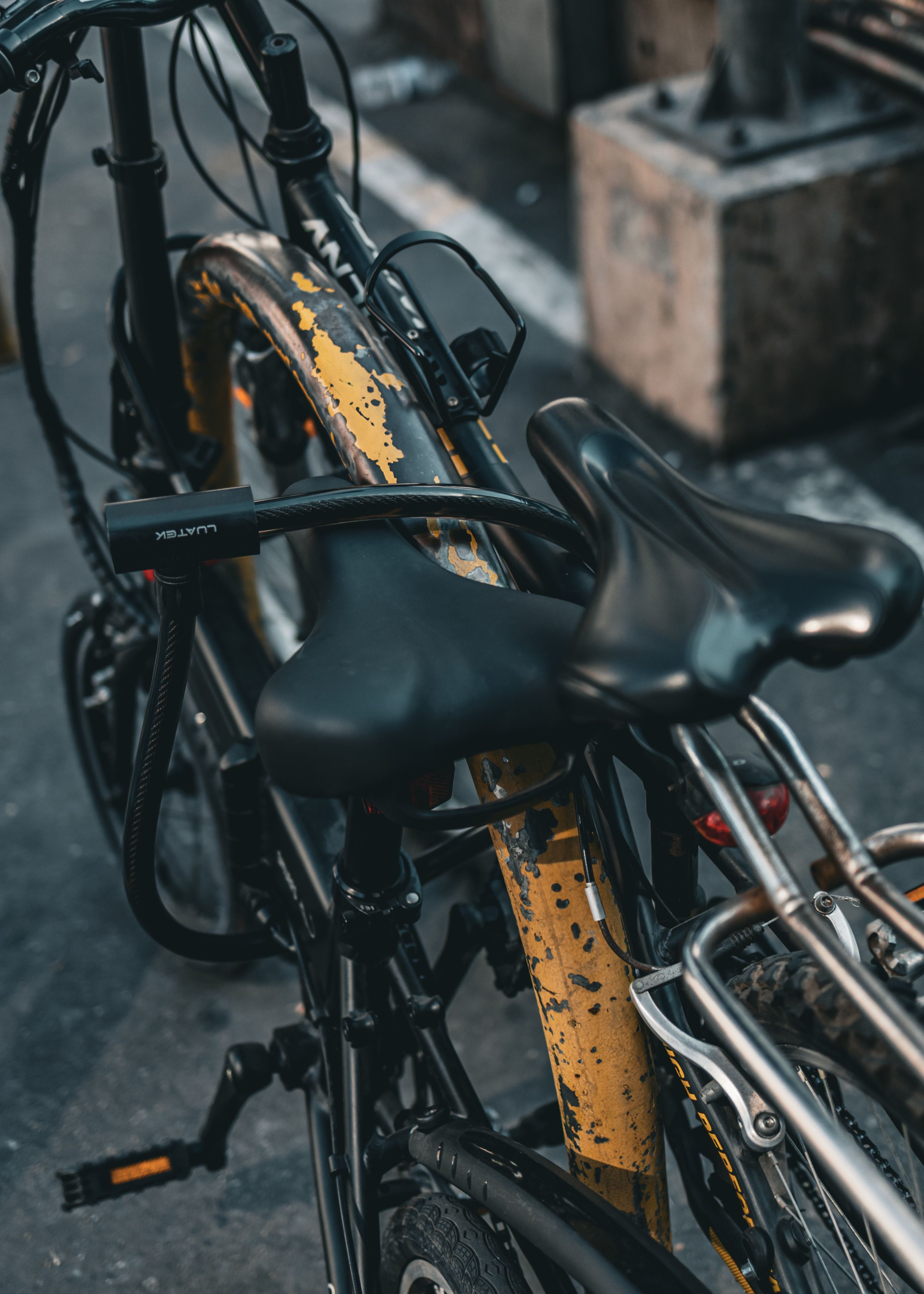 A black D-lock through a bike frame beside the saddle