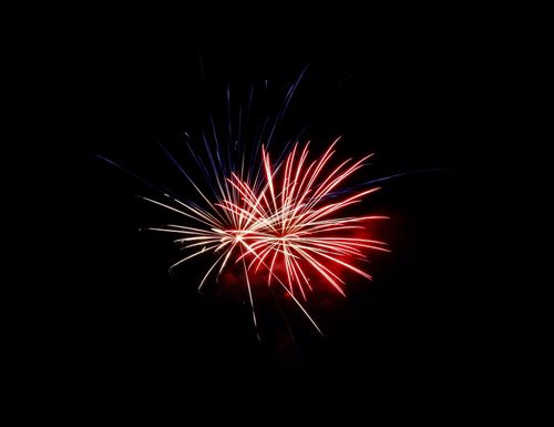 Free A stunning burst of red and white fireworks lighting up the night sky in Winnipeg. Stock Photo