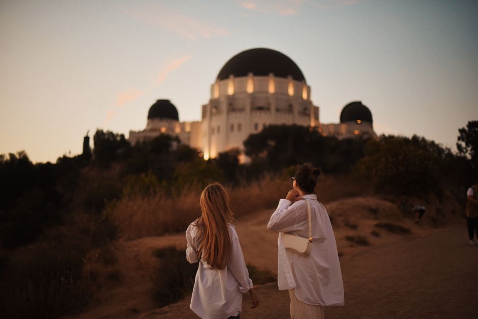 Two friends enjoying a sunset walk at Griffith Observatory, Los Angeles.