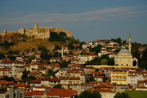 Free Scenic view of a Turkish town with an ancient citadel and mosque at dusk. Stock Photo