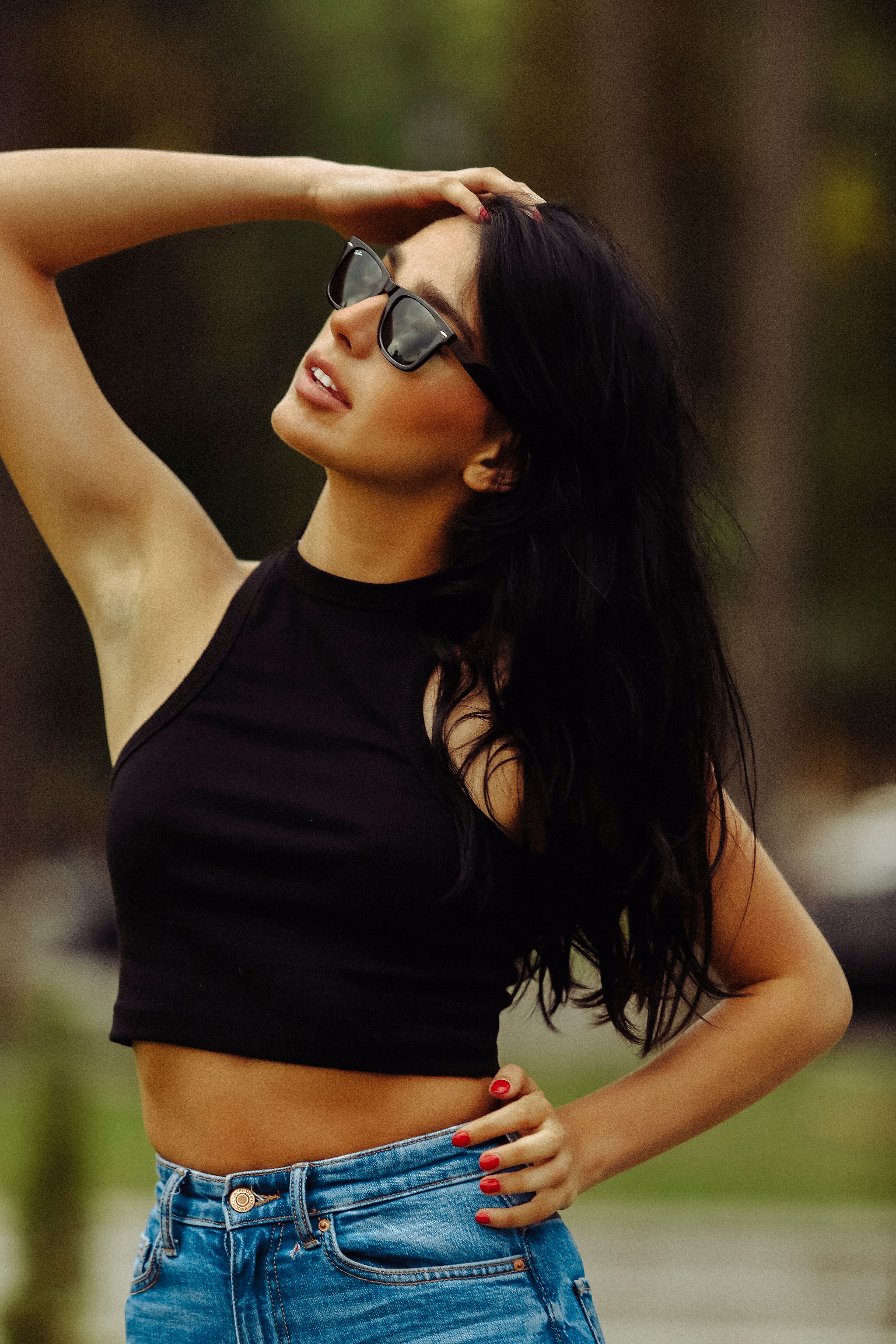 Stylish Woman Posing Outdoors in Sunglasses · Free Stock Photo