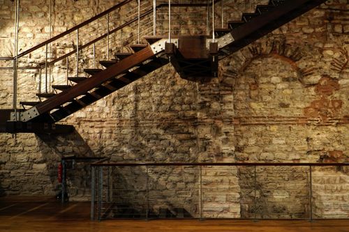 Free Modern staircase against an Ottoman stone wall in Istanbul, blending old and new architecture. Stock Photo