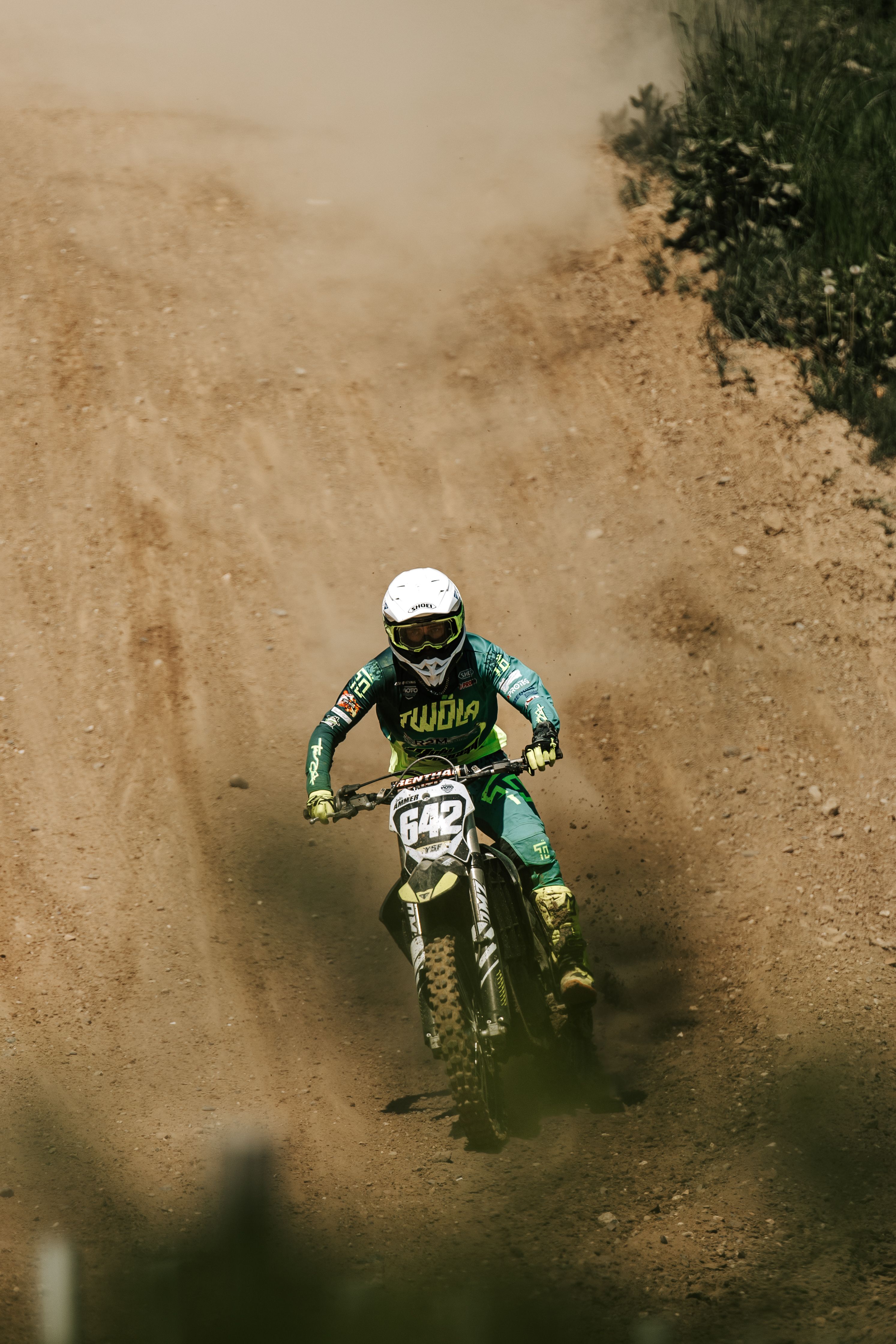 Dynamic Motocross Rider in Action on Dirt Track · Free Stock Photo