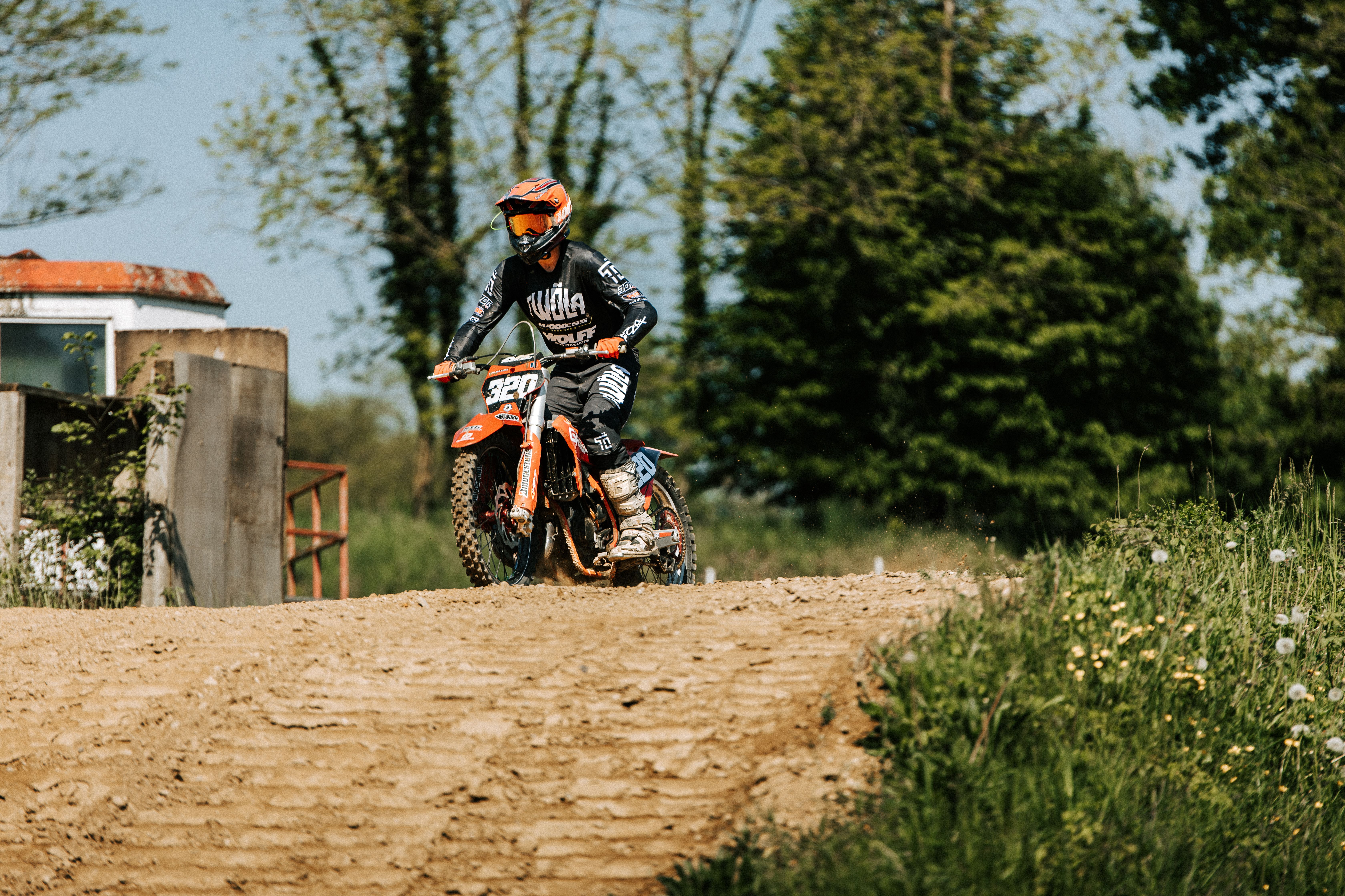Dynamic Motocross Rider in Action on Dirt Track · Free Stock Photo