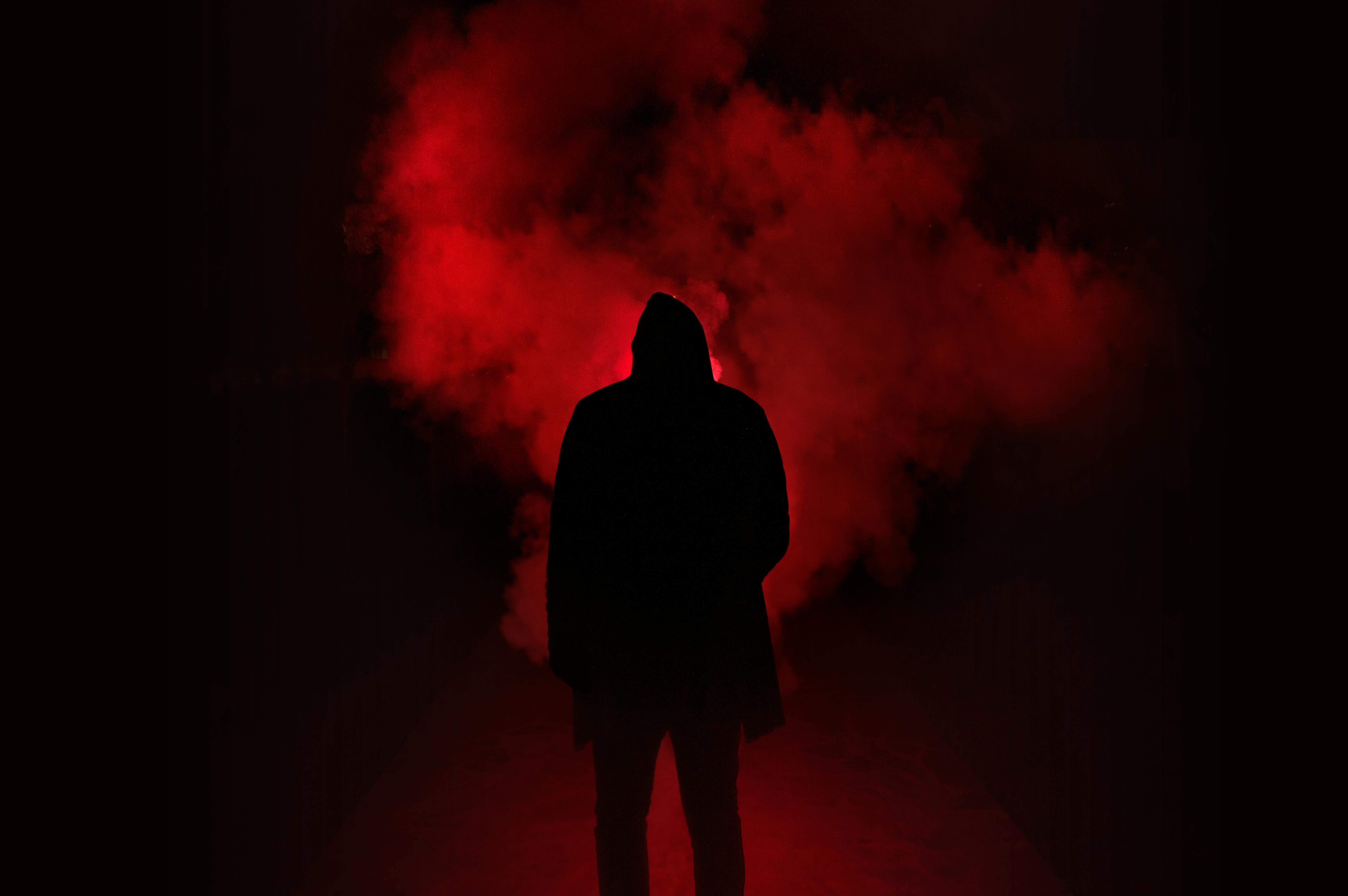 Silhouette of Man Standing Against Black And Red Background · Free Stock  Photo