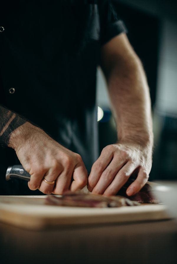 Chef preparing a dish, representing German for Hospitality