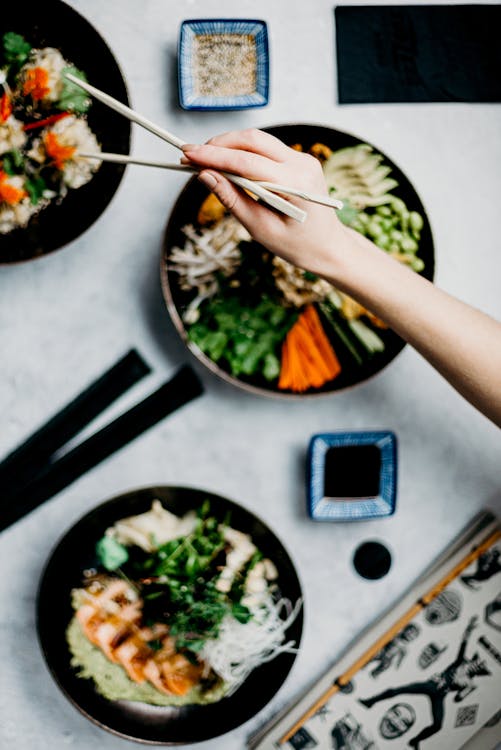 Free Person Holding A Wooden Chopsticks Stock Photo