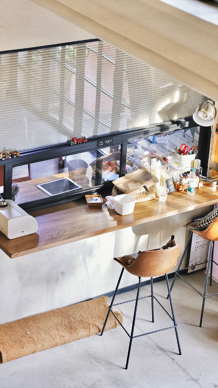 built in corner window seat with a lift up lid used as a small coffee bar