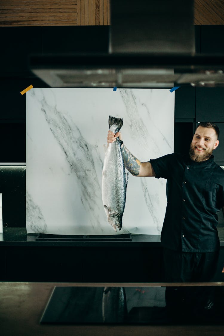 Man Holding Grey Fish