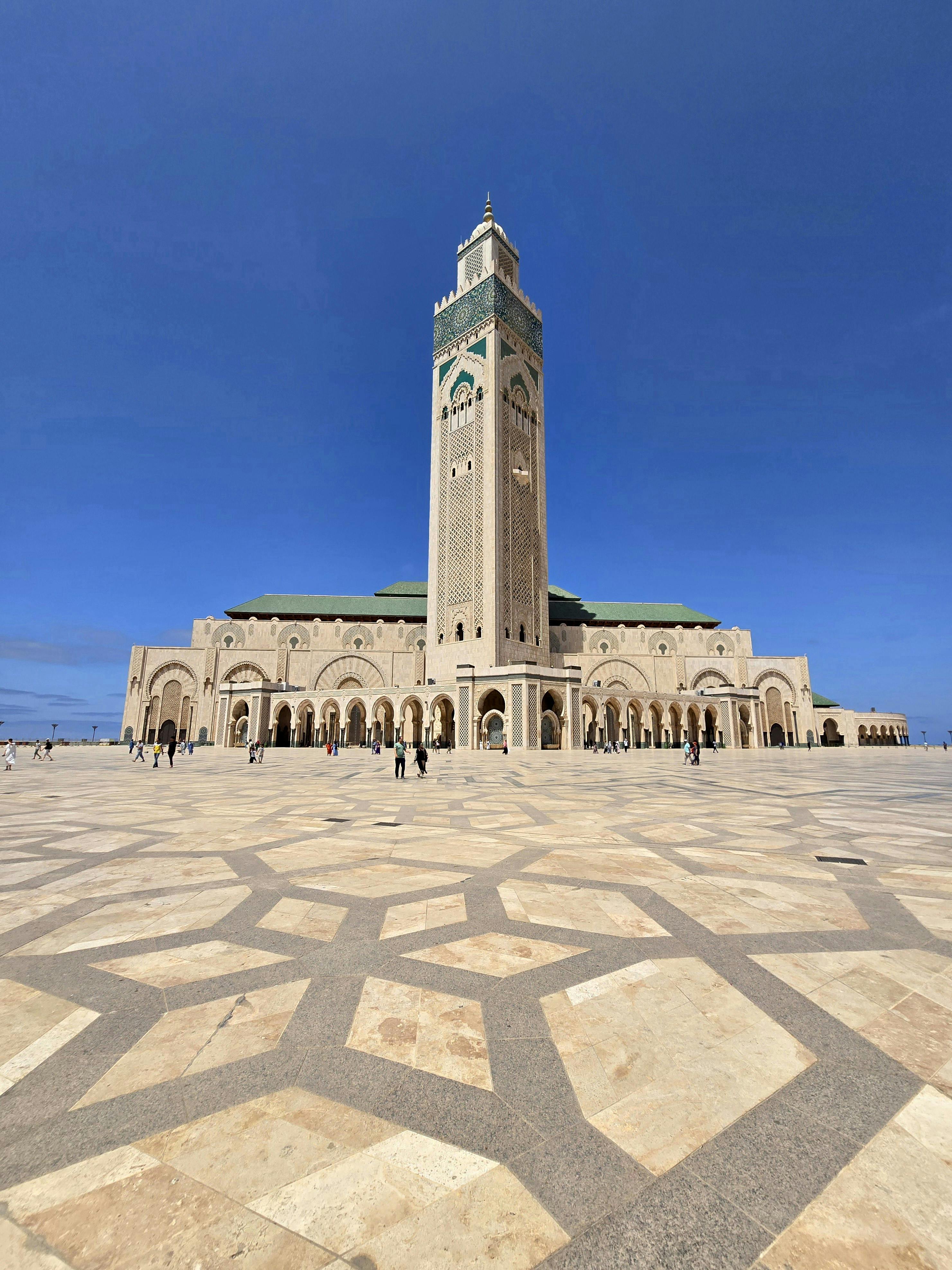 Captivating view of the Hassan II Mosque's architecture under a clear blue sky in Casablanca.